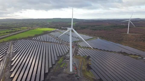 Expansive Solar Panel and Wind Turbine Array in the Irish Countryside Stock Footage 331195468