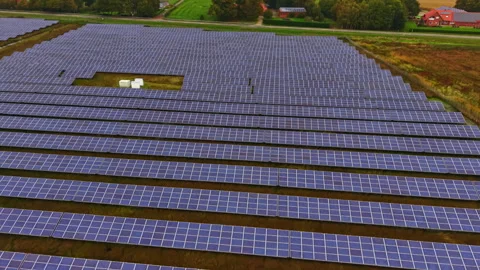Expansive solar panel array harnessing renewable energy in a rural landscape Stock Footage 331403053