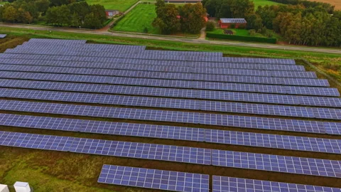 Expansive solar panel array harnessing renewable energy in a peaceful rural Stock Footage 331403249