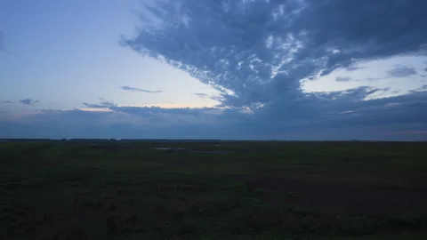 Expansive Storm Clouds Over Flat Dutch Wetlands at Blue Twilight 스톡 동영상 345088995