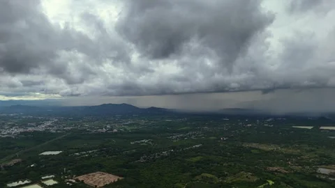 Expansive storm system looms over rural landscape in tropical region of Thailand Stock Footage 314358060