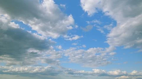 The Expansive Vast Blue Sky Enveloped with Fluffy, White Clouds that Evoke Seren Stock Photos