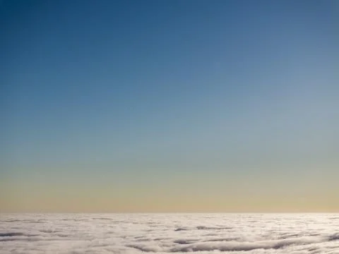 Expansive view of clouds against a clear blue sky during sunset Fotos de archivo