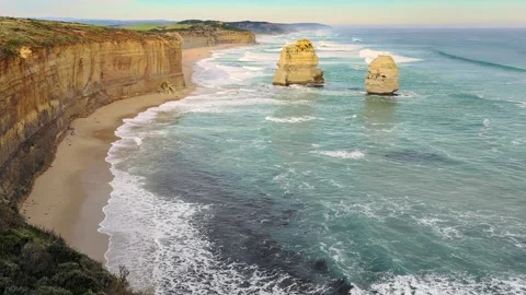 Expansive view of limestone sea stacks isolated in the turquoise ocean by Stock Footage 345288311