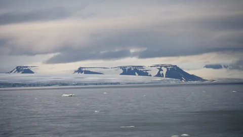 Expansive view of remote icy coastline with snow-covered plateaus, vast open Stock Footage 312209380