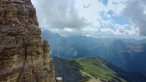 Expansive view of sheer cliffs and green mountains in the Dolomites Italy Video stock 342341577