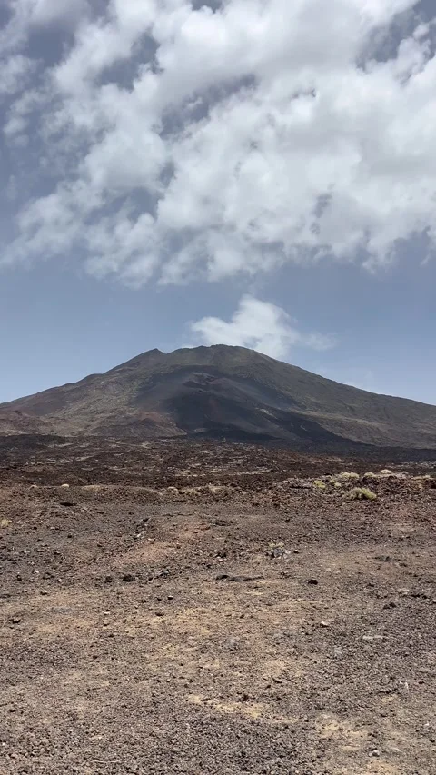 An Expansive View Showcasing the Unique Volcanic Landscape Beneath the Cloudy Stock Footage 318721213
