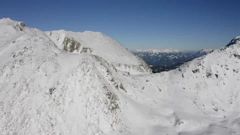 Expansive view of snow-covered mountains under a clear blue sky. Stock Footage 319219642