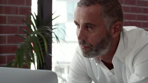 Expat businessman using computer and writing on document. Stock Footage 64099813