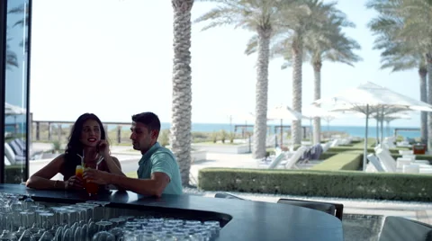 Expat couple with drinks at counter. Stock Footage 64110320