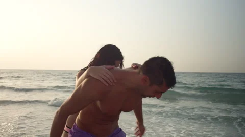 Expat couple having fun at beach. Stock Footage 64111586