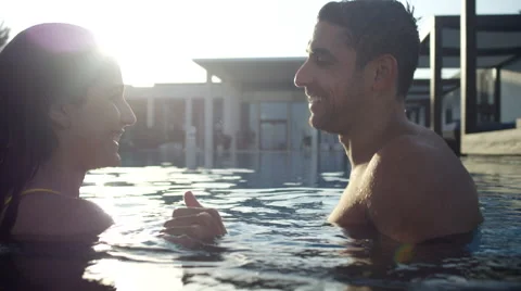 Expat couple in swimming pool. Stock Footage 64112786