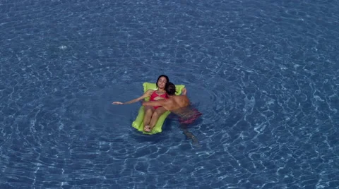 Expat couple in swimming pool. Stock Footage 64113403