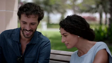 Expat couple using digital tablet at park. Stock Footage 63508933