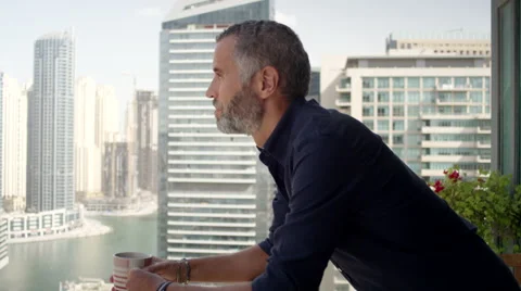 Expat man drinking coffee at balcony. Stock Footage 62426668