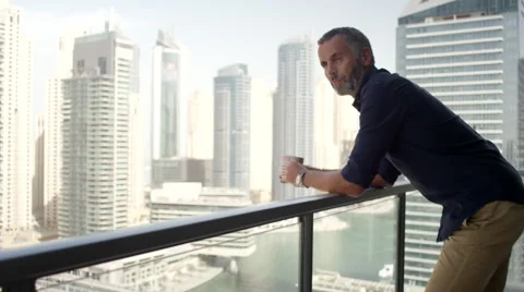 Expat man drinking coffee at balcony. Stock Footage 64119514