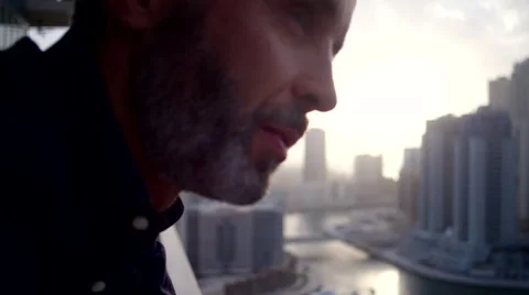 Expat man messaging on mobile at balcony. Stock Footage 62427235