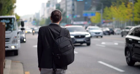 Expat man step down on roadside, looking for his taxi to come, Seoul street Stock Footage 303988109