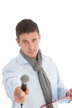 Expectant man holding out a microphone Foto stock