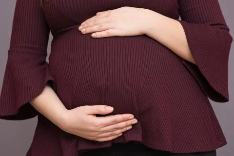 Expectant Mom Holding Her Budding Baby Bump Stock Photos