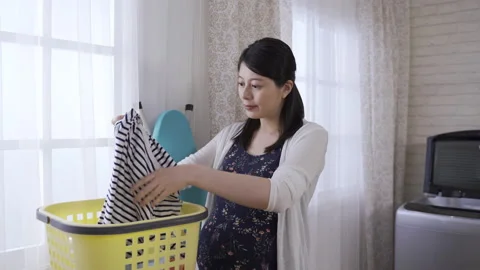 Expectant mother standing by window in room Stock Footage 136747154