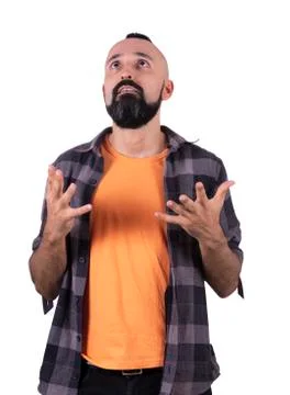 Expectant young hispanic man looking up praying Stock Photos