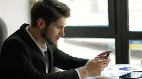 Expected message. Young handsome man using his smartphone with smile while Stock Footage 68598214