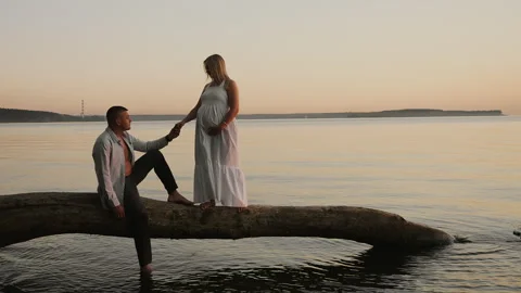 Expecting Couple Holding Hands by Water During Pregnancy. Stock Footage 345292472
