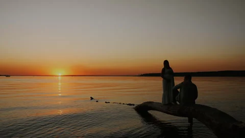 Expecting Couple Together by Water at Sunset. Stock Footage 345311366