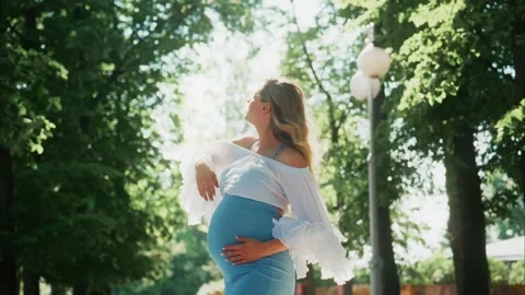 Expecting joy in a sunny park during a serene afternoon stroll with nature Stock Footage 312864914