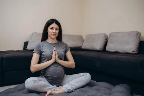 Expecting mom doing yoga exercise in pregnancy Stock Photos