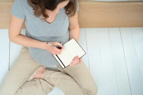 Expecting mom organizing birth notes Stock Photos