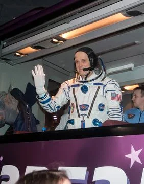 Expedition 55 flight engineer Ricky Arnold of NASA waves farewell as he and.. Stock Photos
