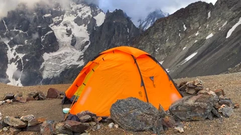 Expedition tent pitched in wide view below Mount Ushba in Svaneti Stock Footage 343770037