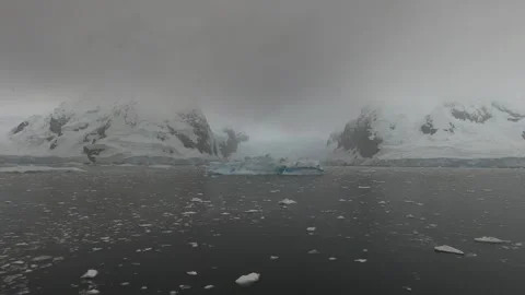 Expedition through icy Antarctic waters near glacier-covered islands, Antarctica Видео 335280264
