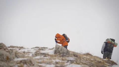 An expedition of two people reached the top. The men made a halt. Stock Footage 106583294