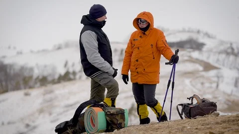 An expedition of two people reached the top. The men made a halt. Stock-Footage 106583384