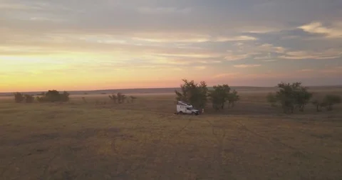 Expedition vehicle camping in steppe at sunset. Stock Footage
