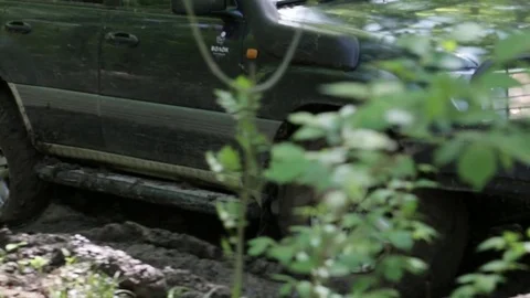 Expeditionary SUV slowly rides through the forest. Stock Footage 75846972