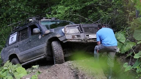 Expeditionary SUV trying overcom difficult area via winch. Stock Footage 75883904
