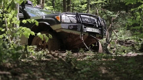 Expeditionary SUV trying overcome difficult area via winch. Stock Footage 75883286