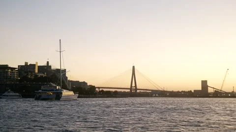 A expensive boat lit up with lights heading to Sydney's Anzac Bridge 6K Video stock 304407325