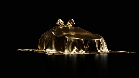 Expensive car gift covered by gold shiny fabric with bow-knot Stock Footage