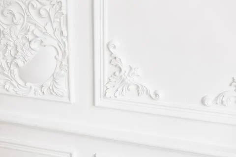 Expensive interior. Stucco elements on light luxury wall. White patterned 스톡 사진
