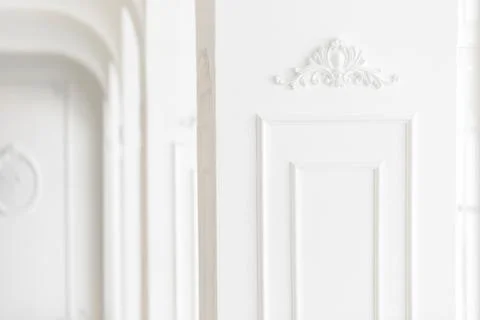 Expensive luxury interior. Stucco elements on light column. White patterned Stock Photos