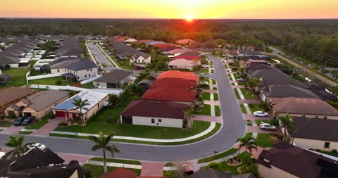 Expensive mansions between green palm trees in southwest Florida suburbs, USA Stock Footage 344695485