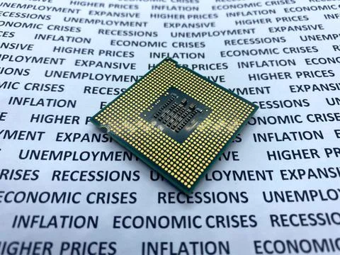 Expensive microprocessor chip closeup view on a paper with text economic cris Stock Photos