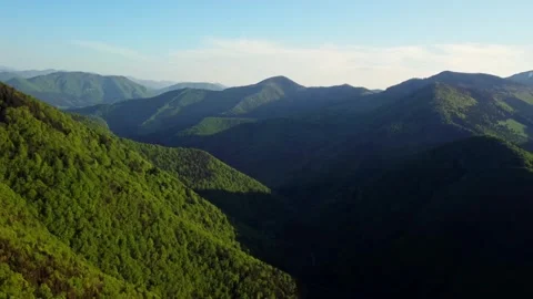 Experience the breathtaking aerial views showcasing lush green mountain Stock Footage 293708399