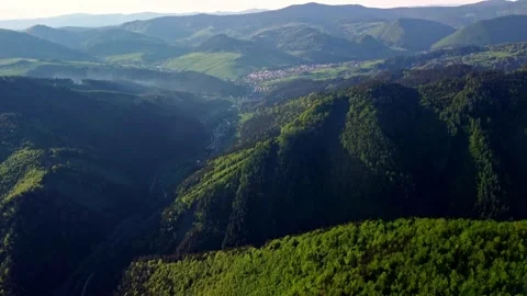Experience the breathtaking aerial views showcasing lush green mountains along Stock Footage 293708763