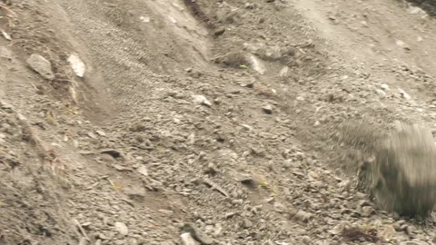 Experience the breathtaking slow motion tracking shot of a massive boulder Stock Footage 128450833